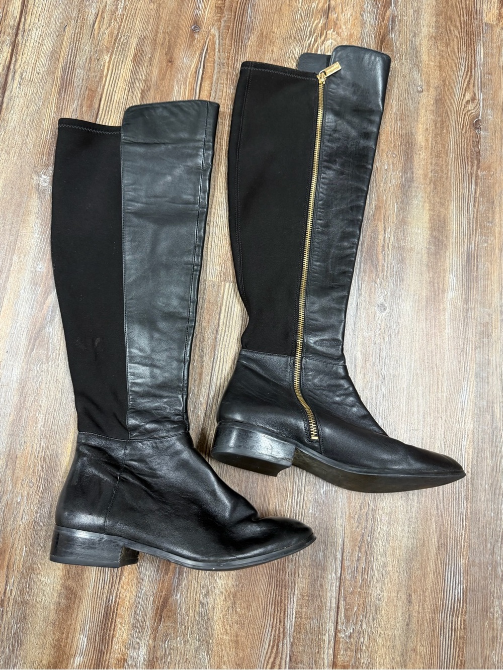 Michael Kors Black leather knee-high boots with gold zipper detail